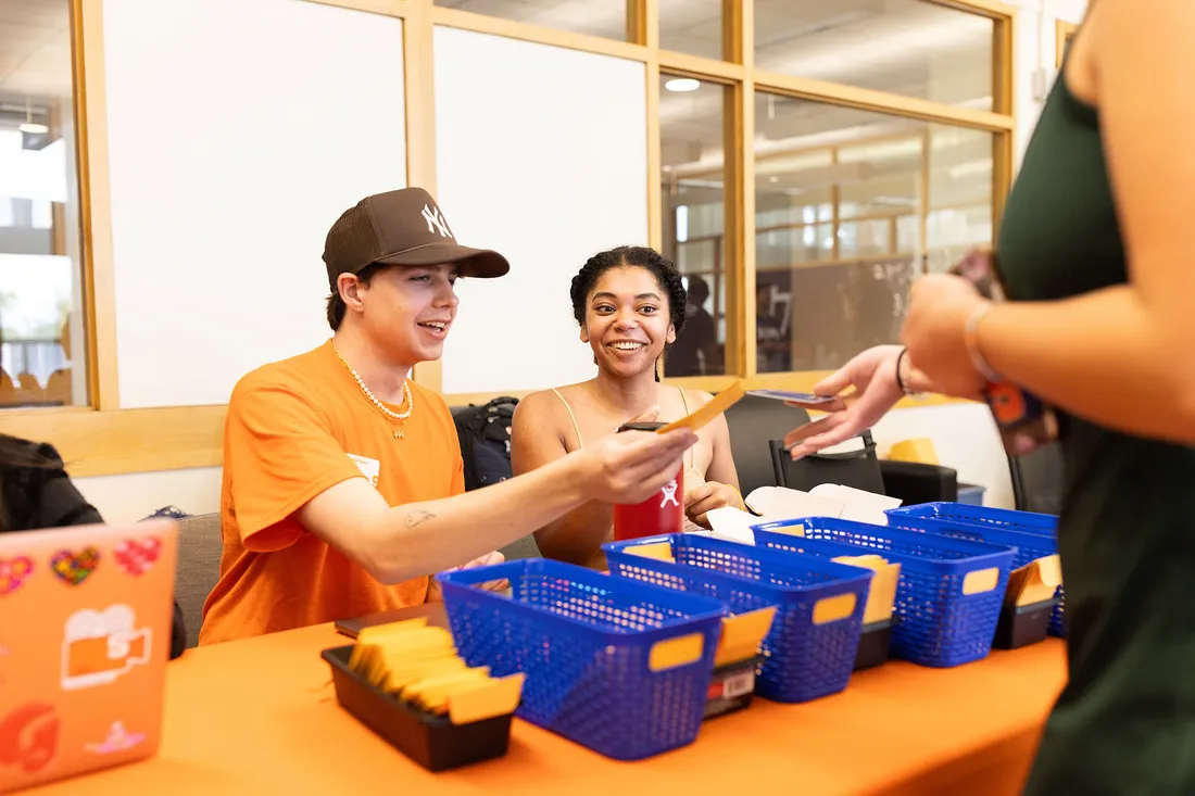 Students hand out dorm keys at move in.