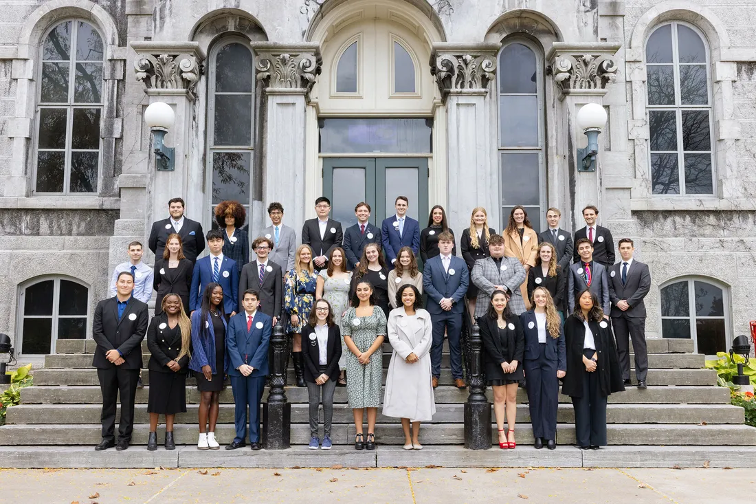 Group of students standing on steps for group photo.