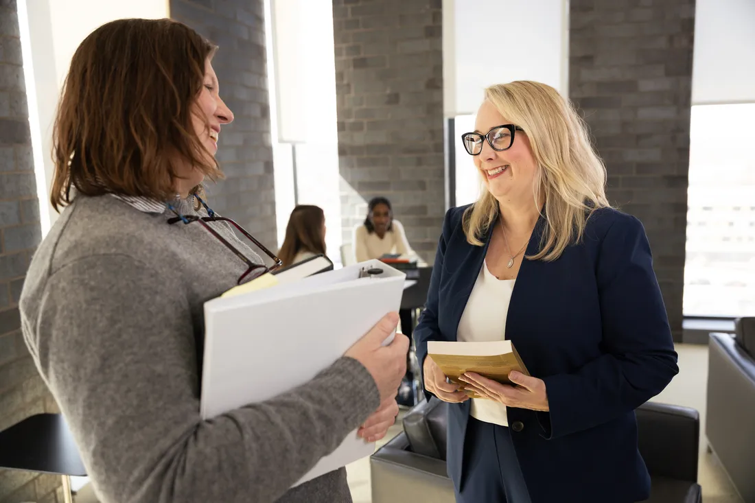 Professor Kat MacFarlane talking with students.