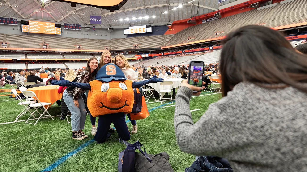 Admitted students posing for a photo with Otto.