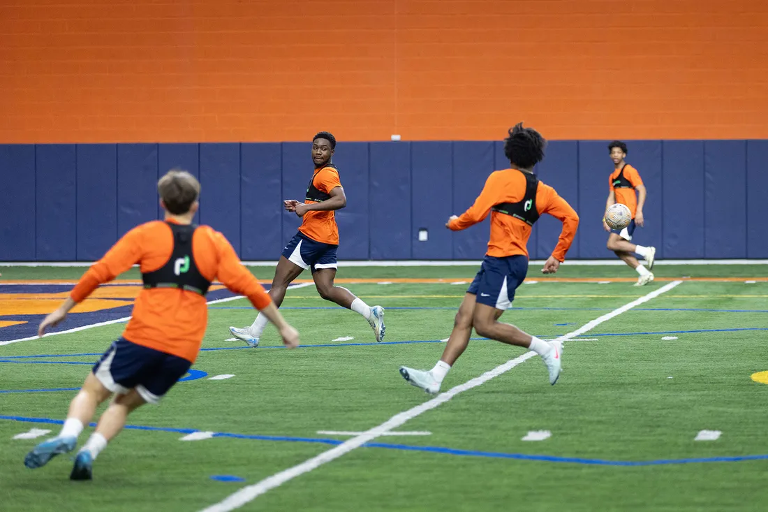 People playing soccer with tracking devices.