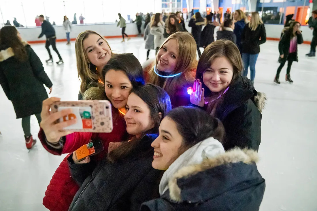 Group of students takes a selfie on ice skating rink