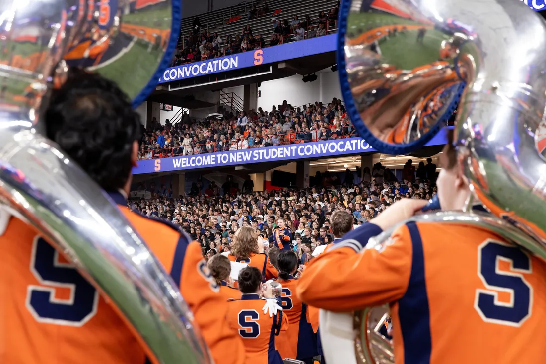 People in the marching band playing instruments.