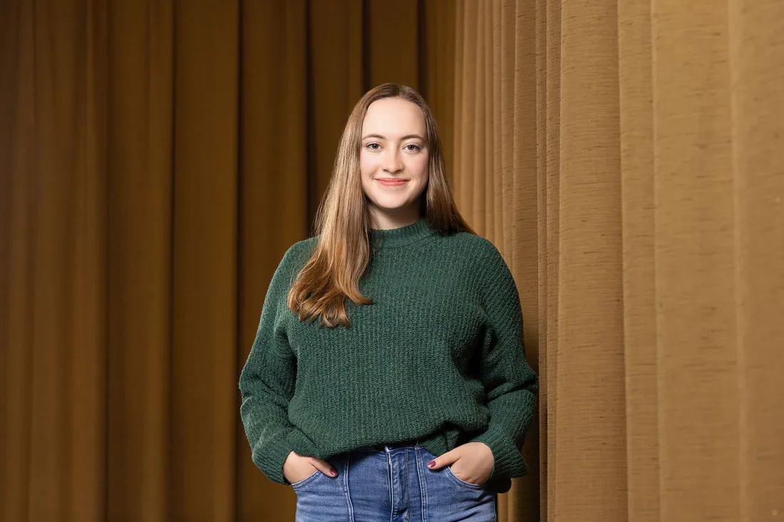 Portrait of Savannah Devlin standing on stage.