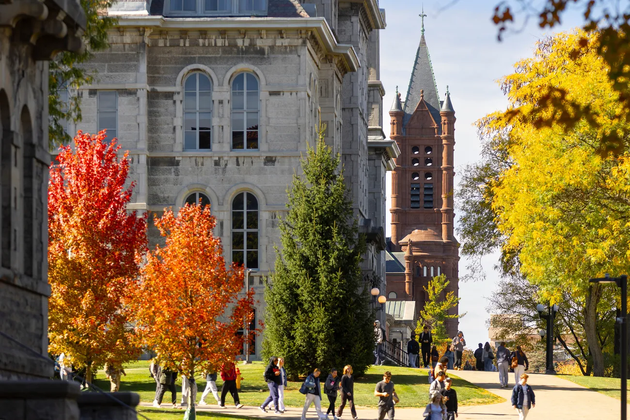Aerial photograph of Syracuse University campus on a blue sky autumn day with students walking.