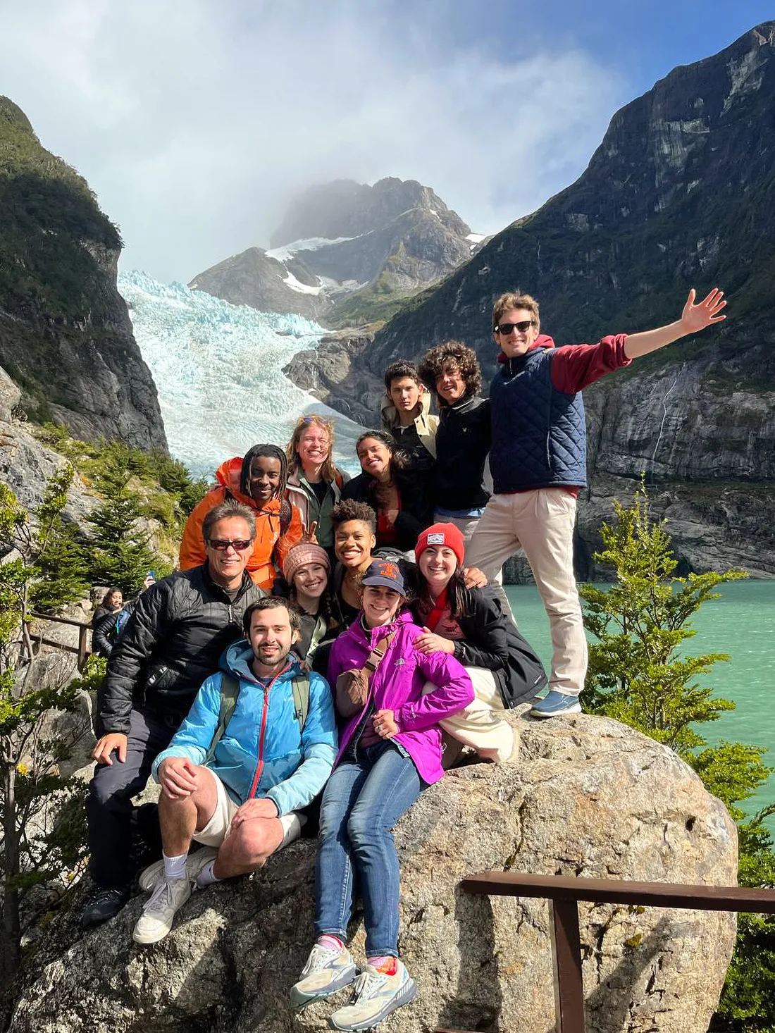 People posing for a picture on a rock while hiking in the Patagonia.