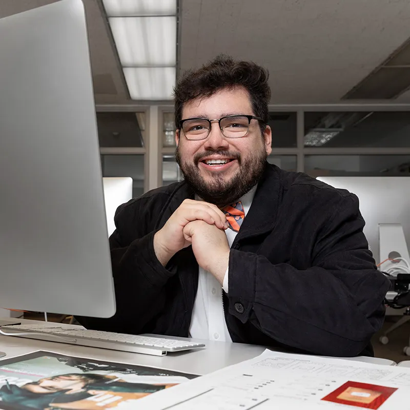 Kevin Camelo Bonilla sitting in front of computer.