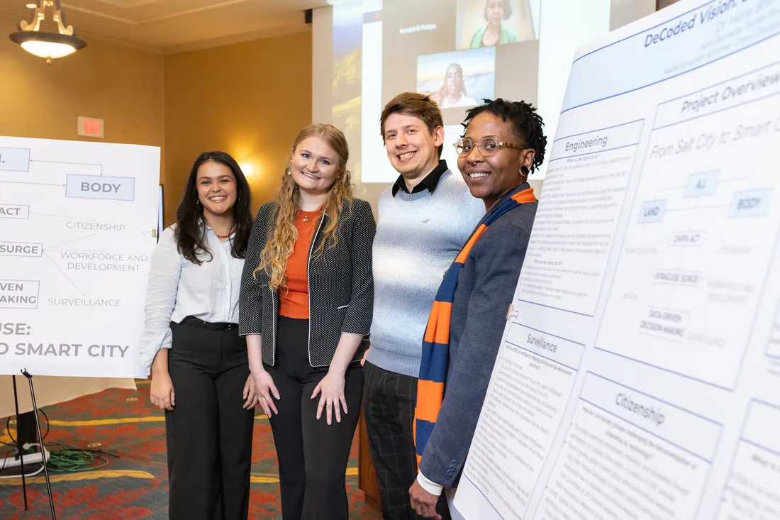 A group of students standing in front of a symposium board together.