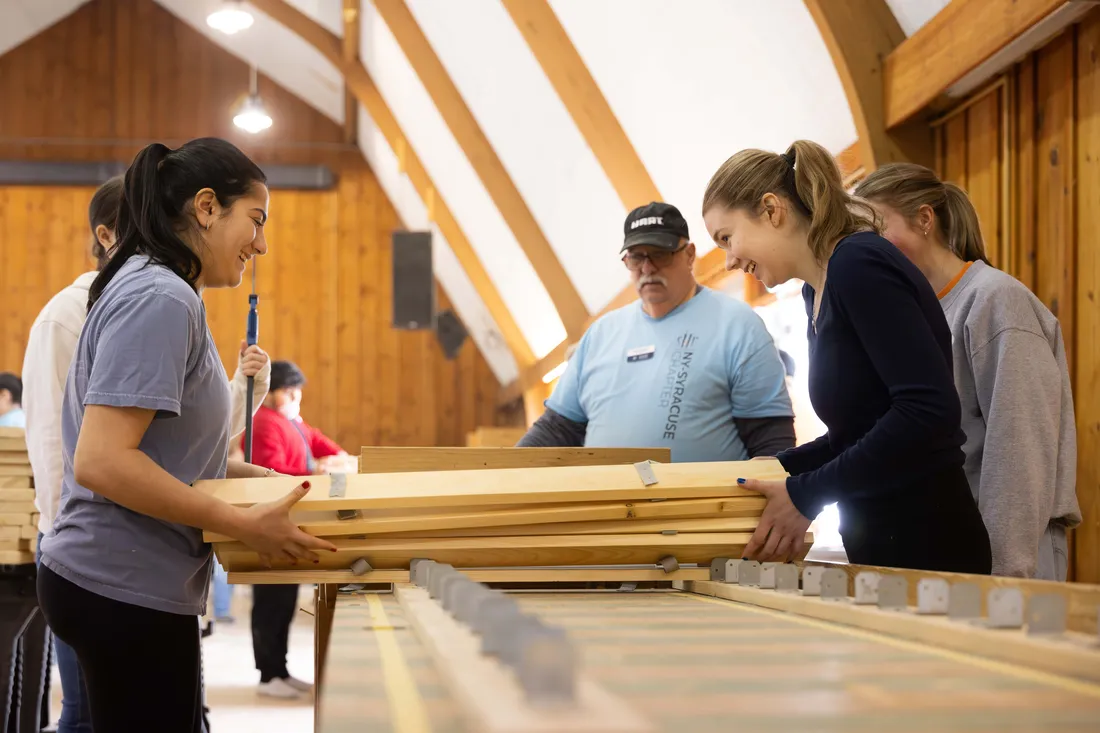 Students from the campus volunteer organization work together to build beds for local children for the local community group, Sleep in Heavenly Peace, Spring 2025.