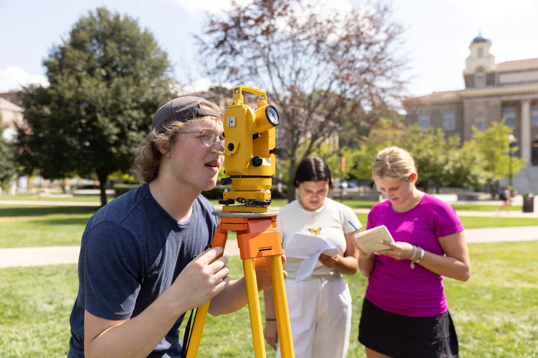 Students surveying on campus.