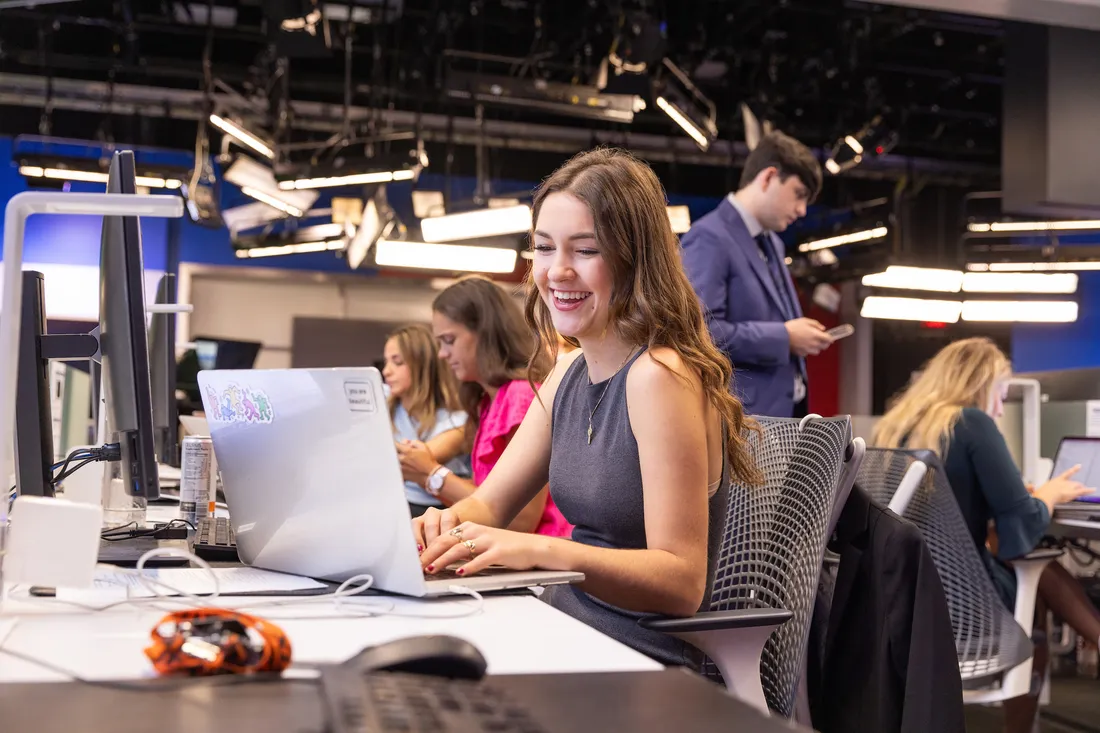 Student working on a computer during a news production class.