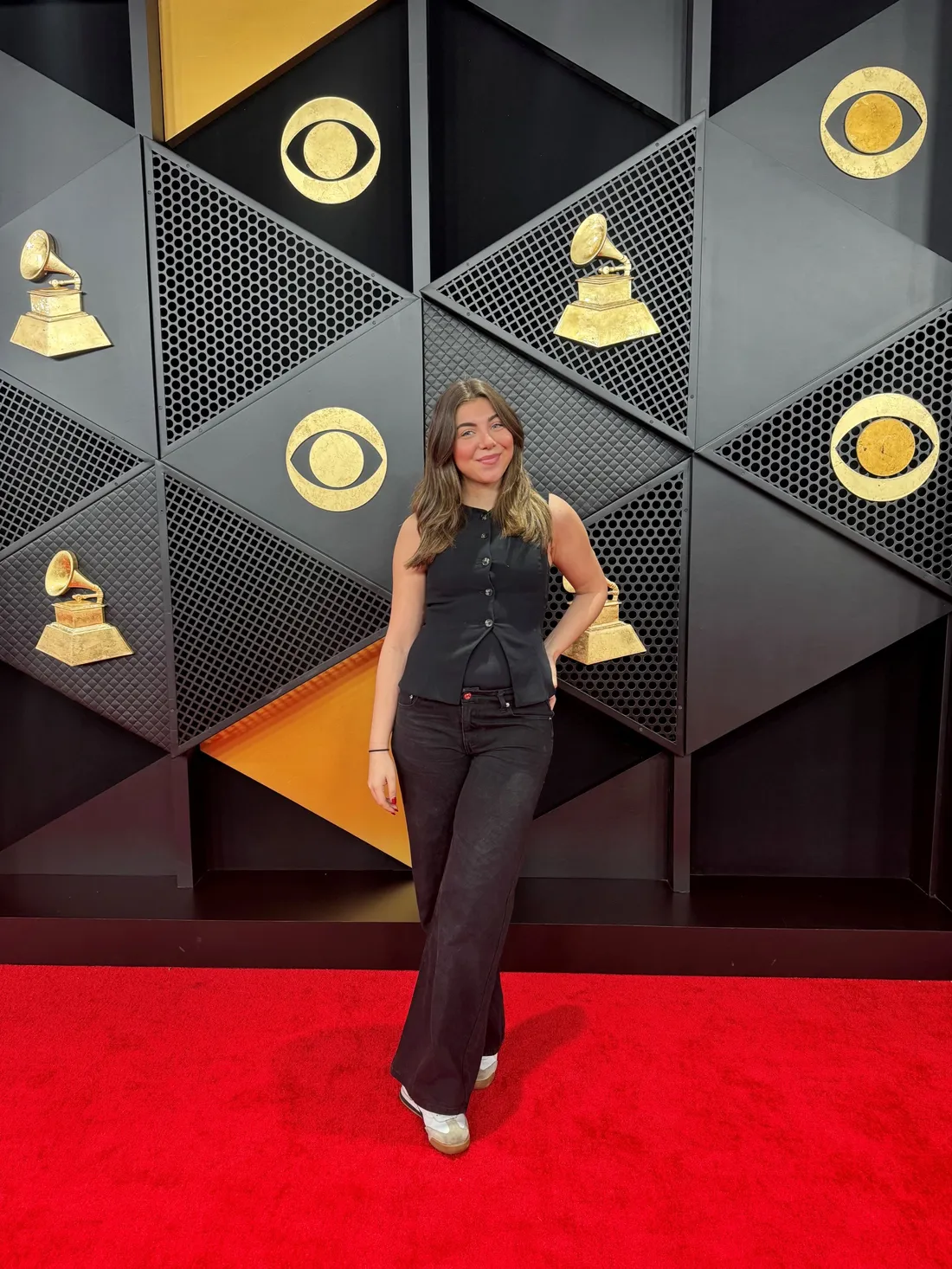 Taylor Lokoff '25 posing and smiling on the red carpet at the Grammy Awards.