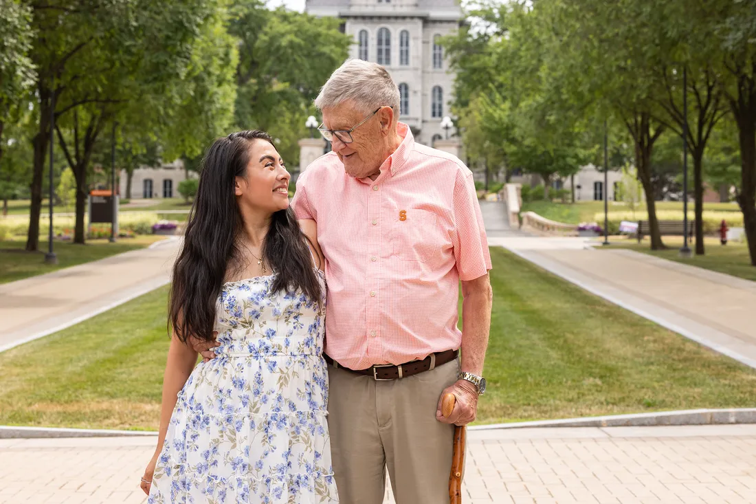A grandfather and granddaughter standing in front of the Hall of Languages.