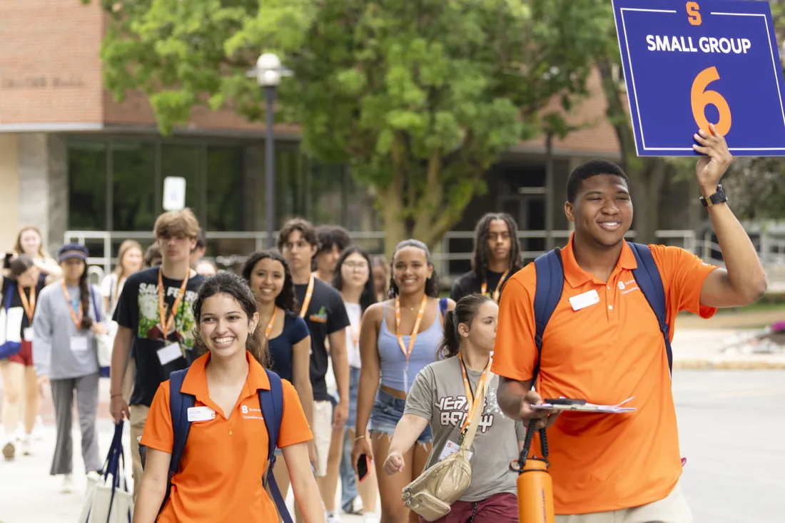 Zeke Whitley '29 and another orientation leader walking students through a tour of campus.