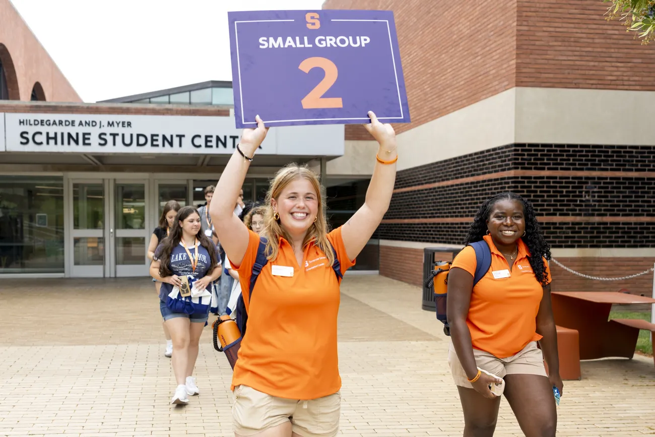 Student orientation leaders walking outside of the Schine Student Center.