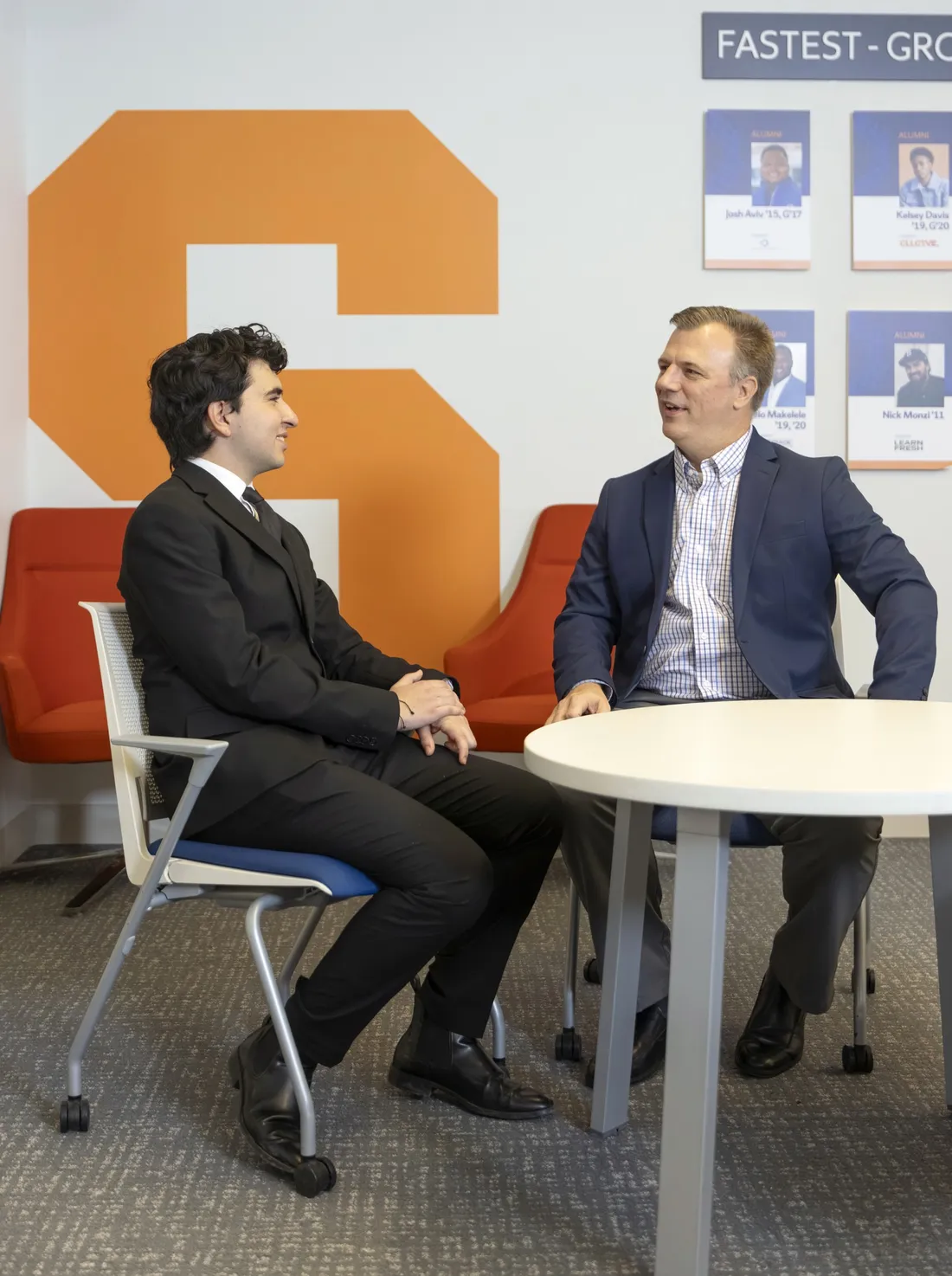 Bruno Arriola ’28 sitting and talking with Frank Shultz '03 at the Couri Hatchery.