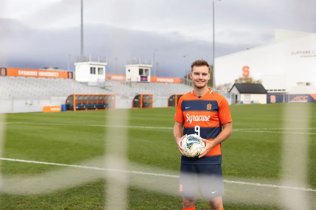 Julius Rauch ’24 on a soccer field holding a ball.