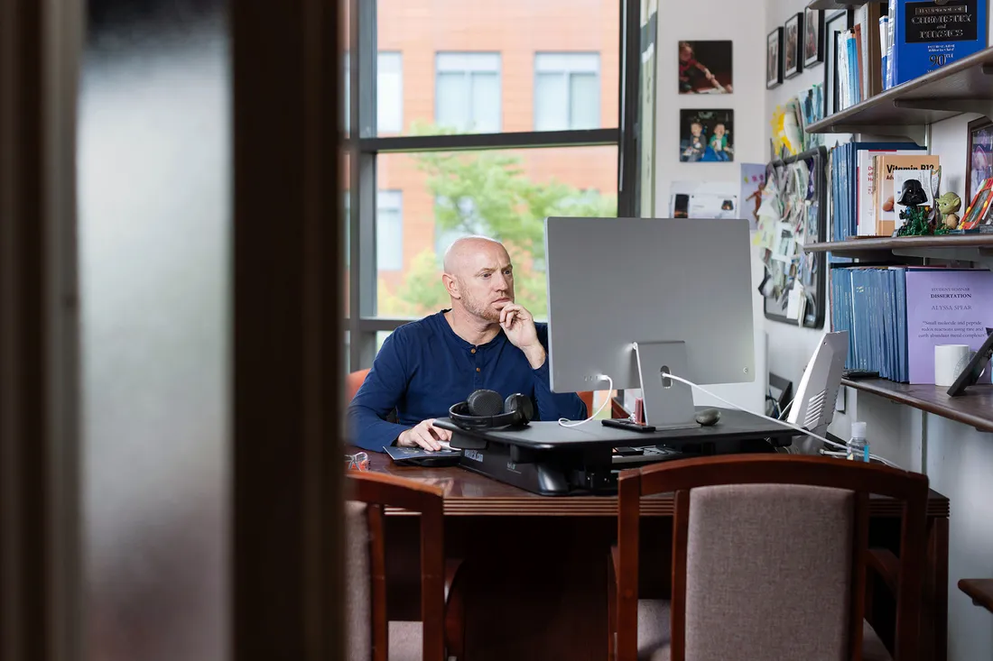 Robert Doyle works on computer in faculty office.