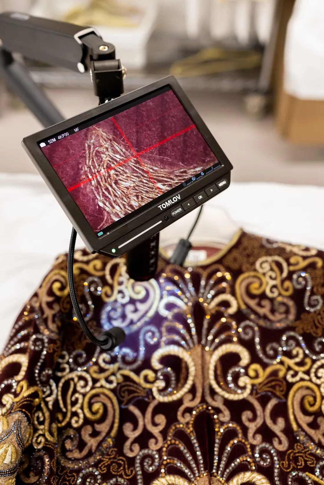 A camera analyzing the close up view of the materials of a shirt.