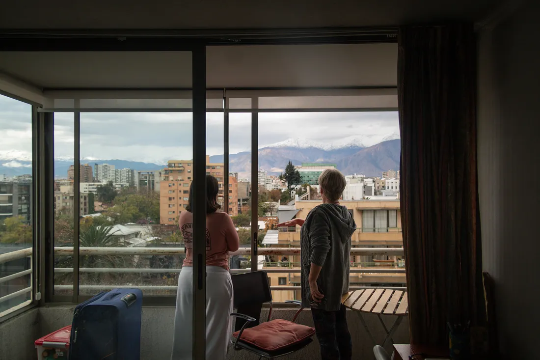 People standing on a balcony enjoying the skyline view of Santiago, Chile.