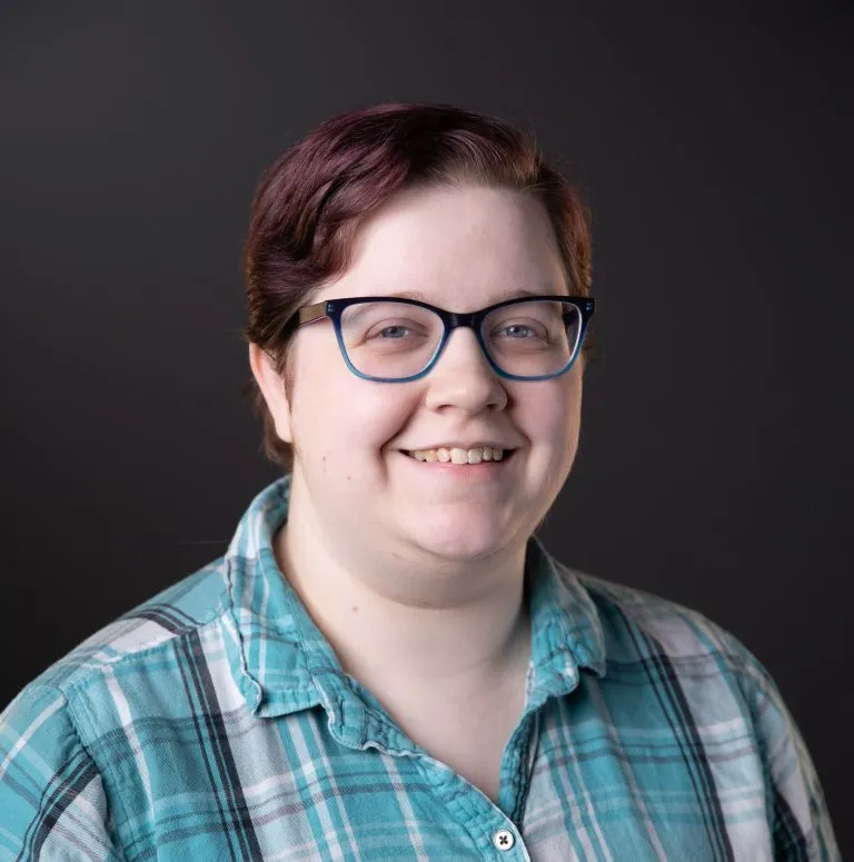 Jeanette Haselberg smiling in a plaid shirt.