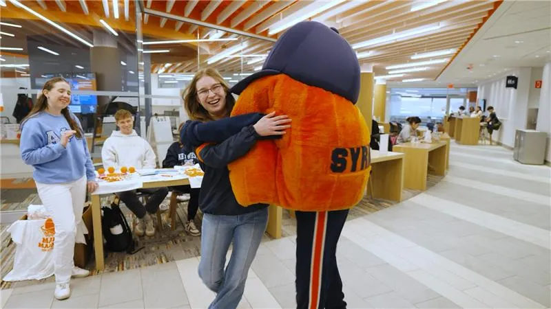 Jordan Winkleman hugging Otto the Orange.