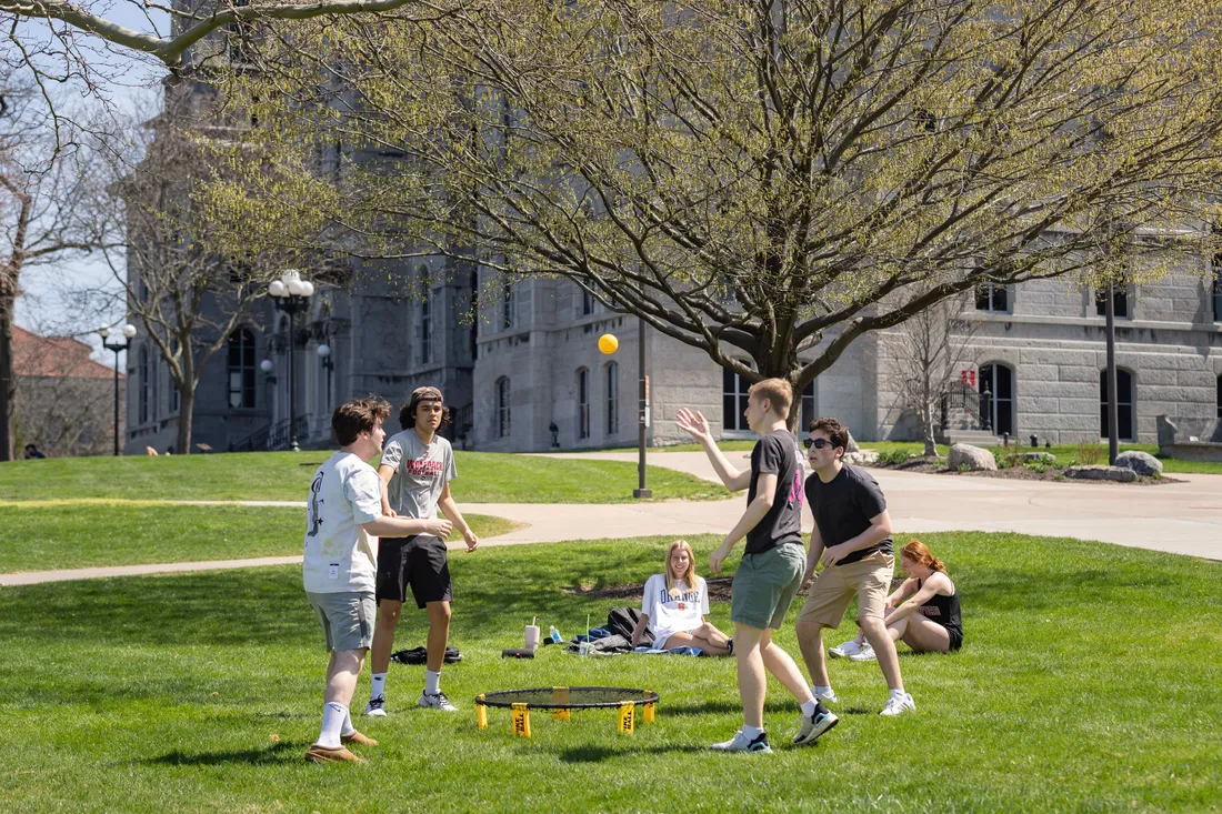 Students outdoors playing spike ball.