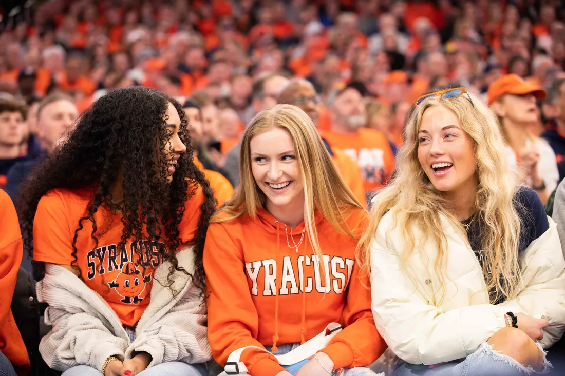 Students smiling at a game.