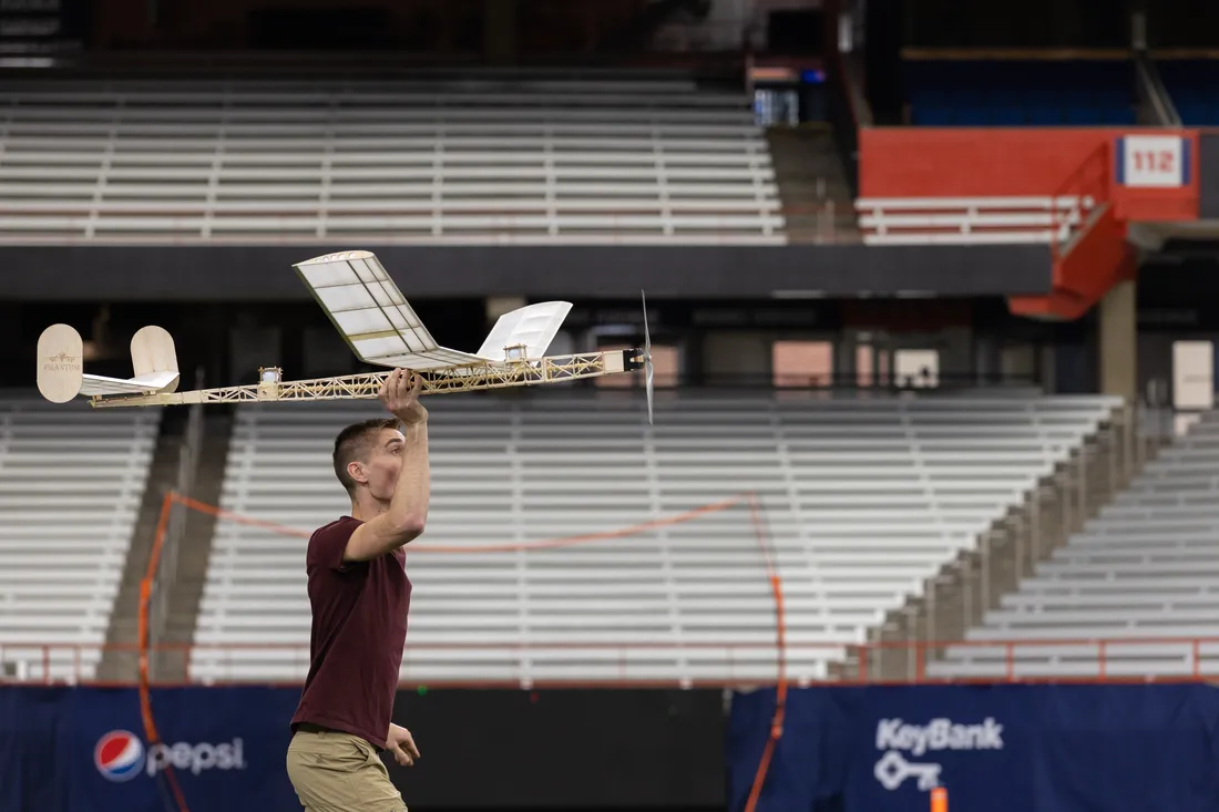 Individual demonstrating flight at Aerospace Engineering Flight Day at Syracuse University.