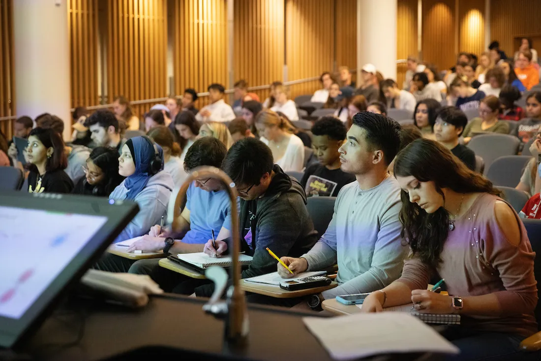 Students sitting in lecture hall.