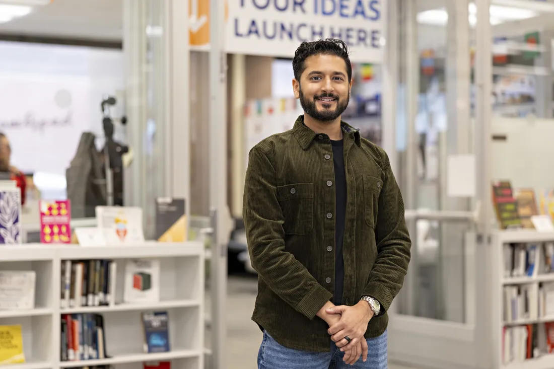 Rah Mahtani outside of Blackstone Launchpad in a Syracuse University library.