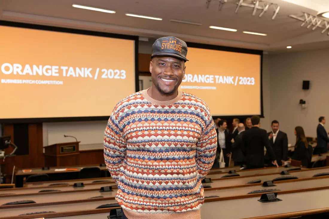 Person standing in front of a presentation room.