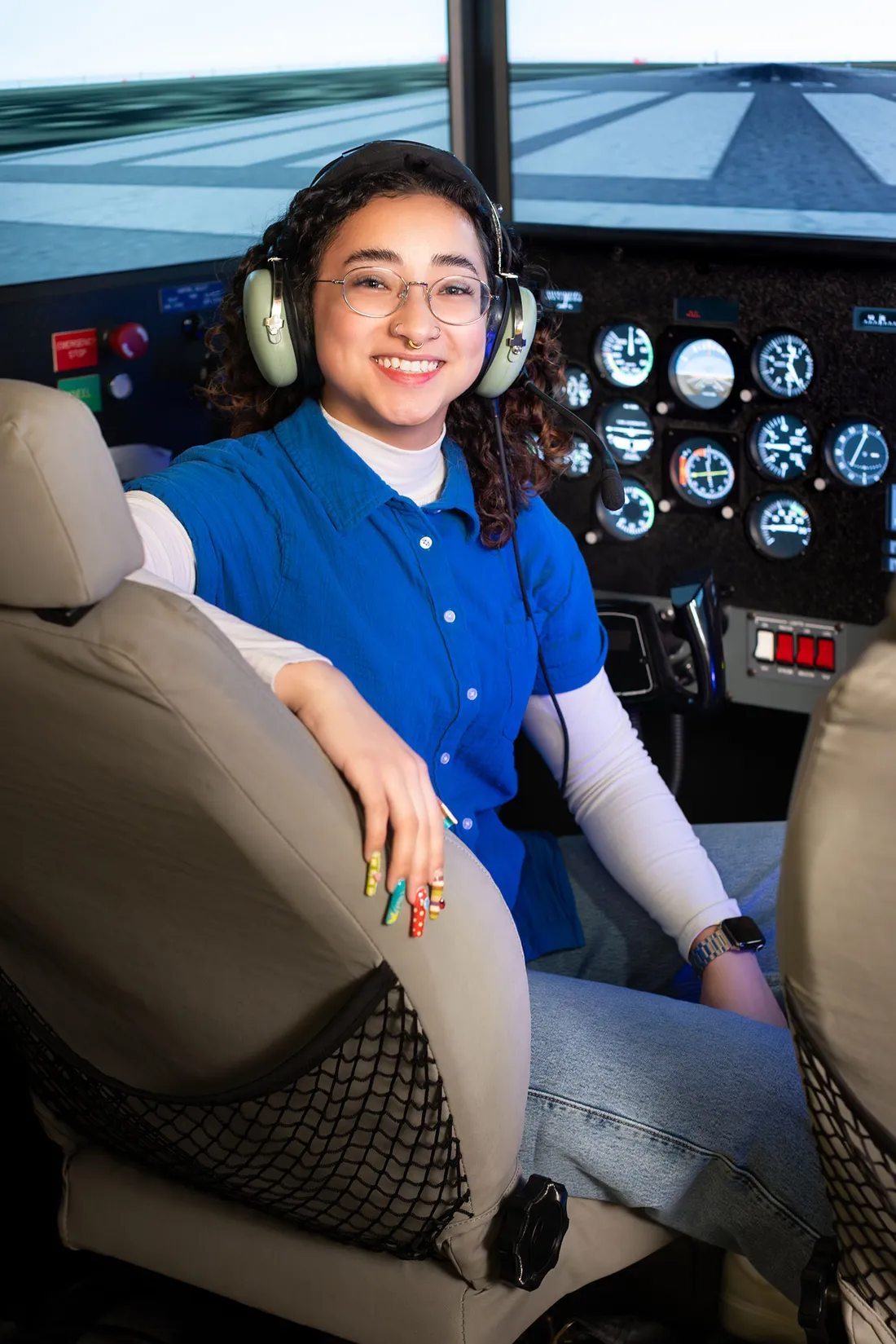 Allyson Almeida is in the cockpit of a plane.