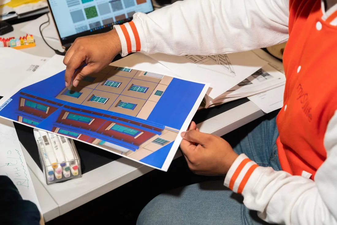 Architecture students work on a project of building prints.
