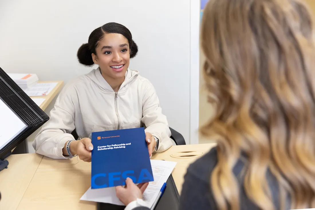 Student sits with advisor in the career services office.