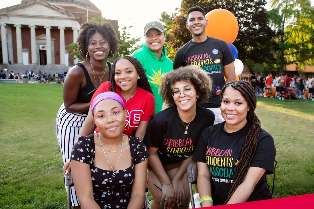 Students pose for picture together on the quad.