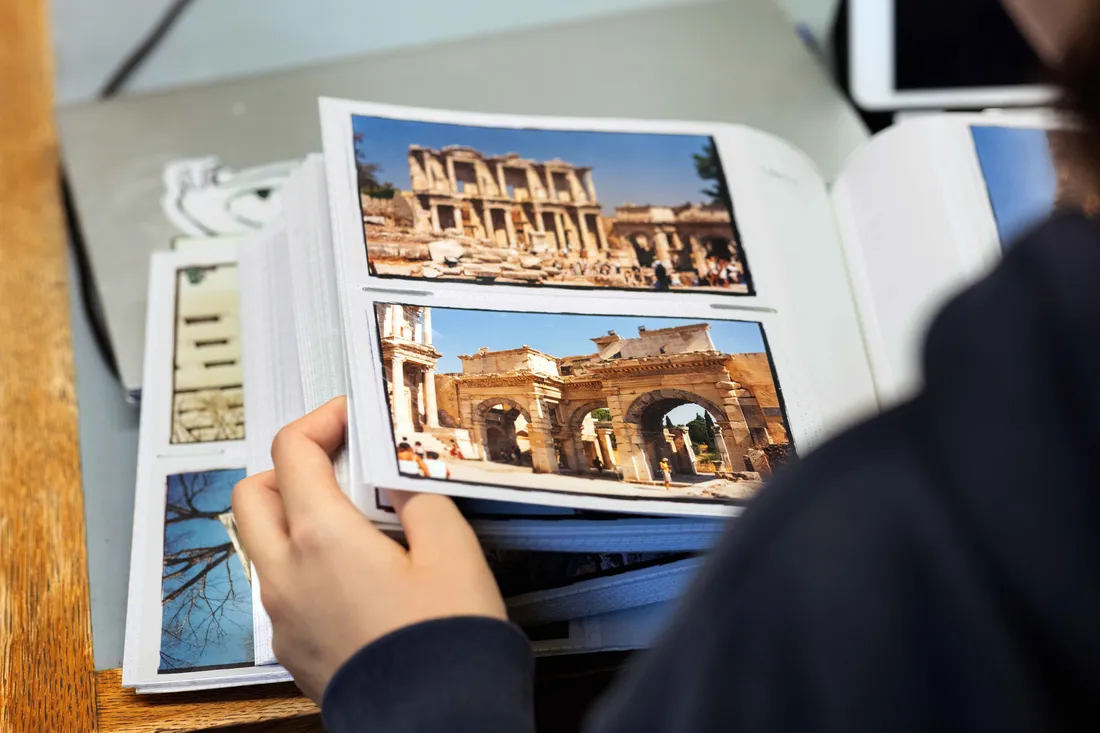 Person looking through a picture book.