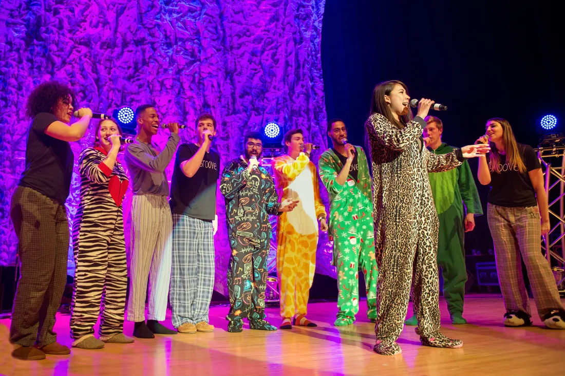 A group of student sing on stage.