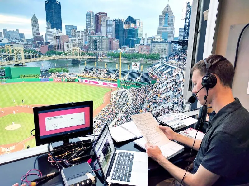 Kevin Brown in press box calling baseball game.