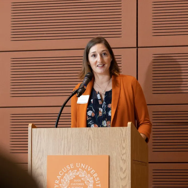 Lisa Manning stands at a podium.