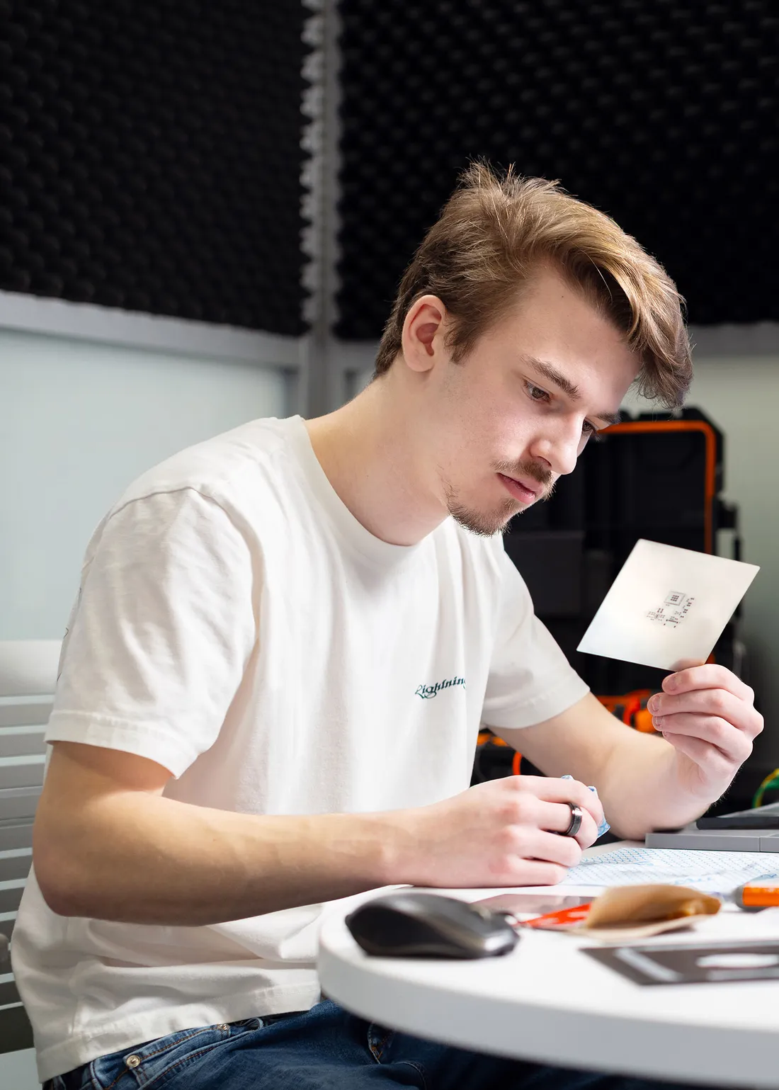 Tony Gonclaves working on something and looking at an index card.
