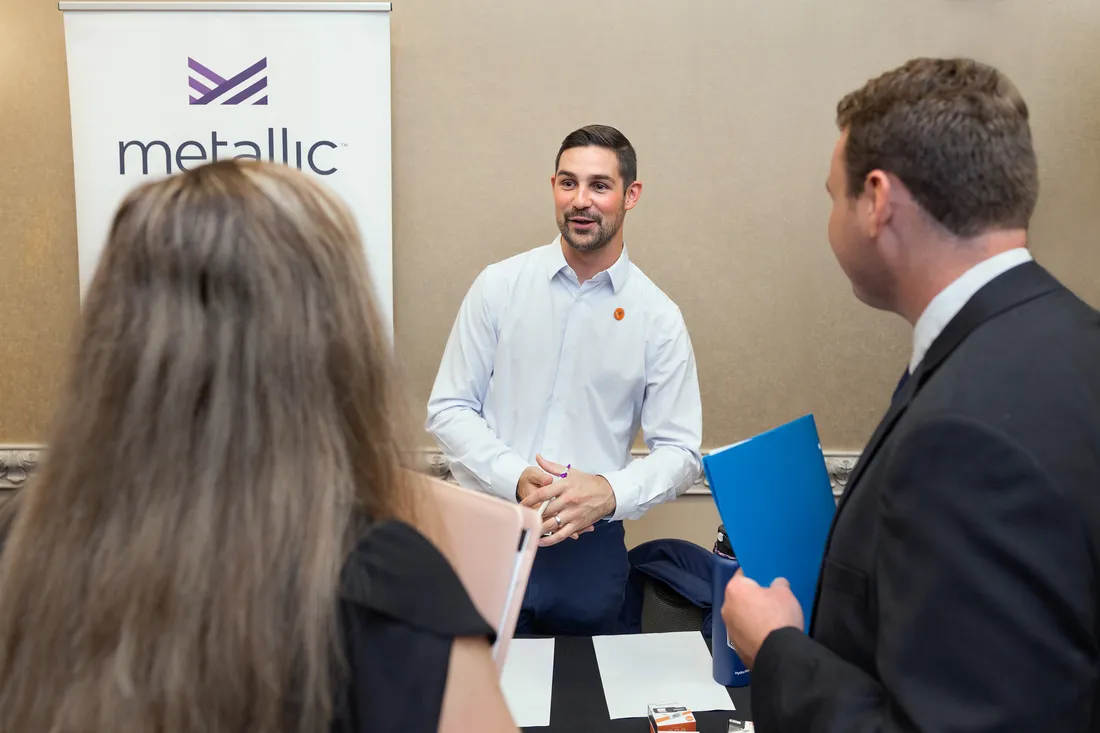 Kelly speaking to students at a table.