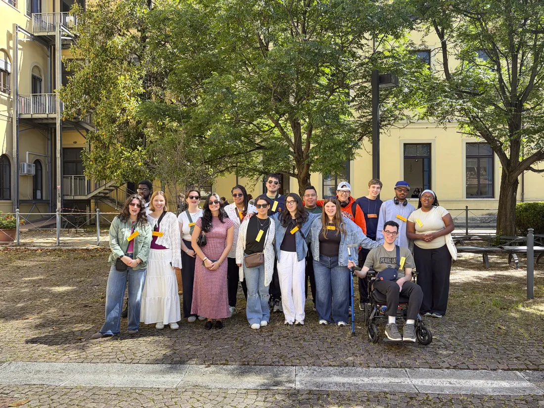 Group of students standing and smiling together outside in Italy.