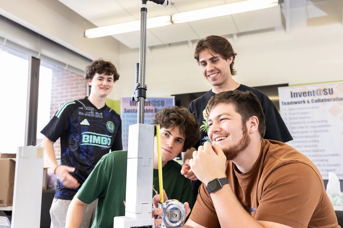 Four students working on an engineering project.