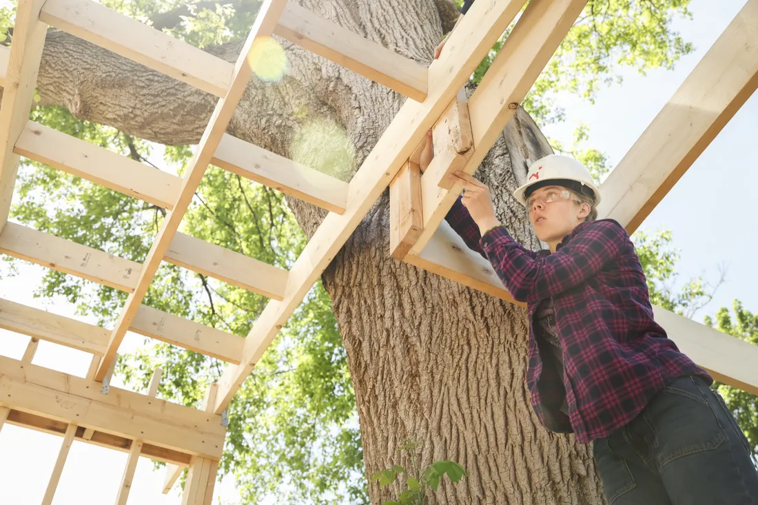Person building tiny home.