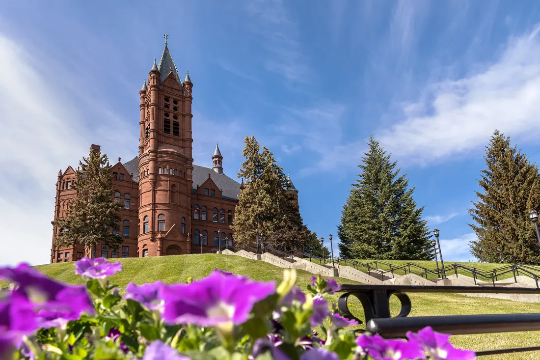 Syracuse University's Crouse College with purple flowers.