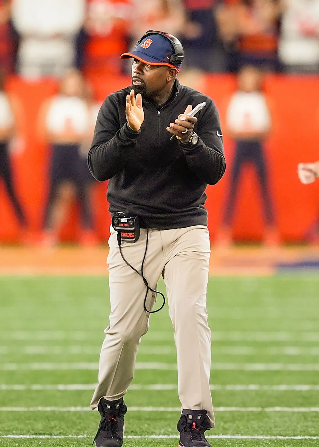 Fran Brown walking on a field.