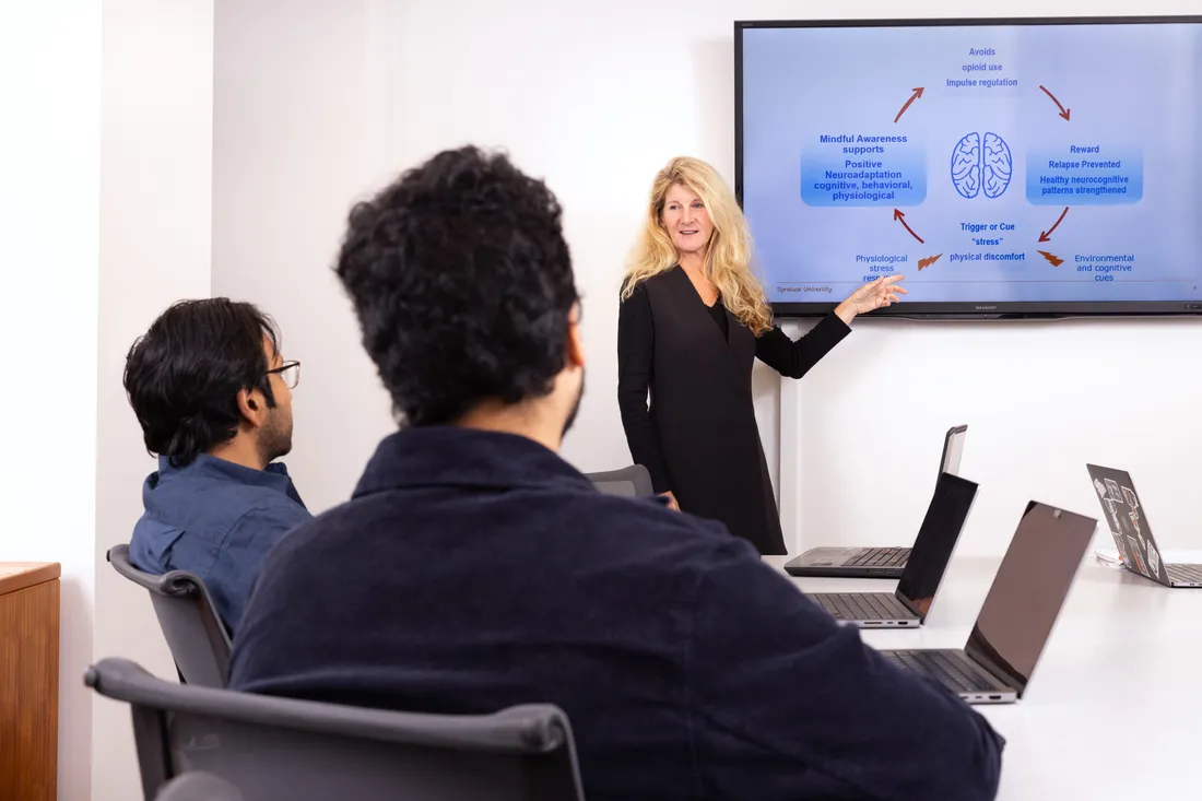 Public health professor Dessa Bergen-Cico ’86, G’88, G’92 pointing to screen.