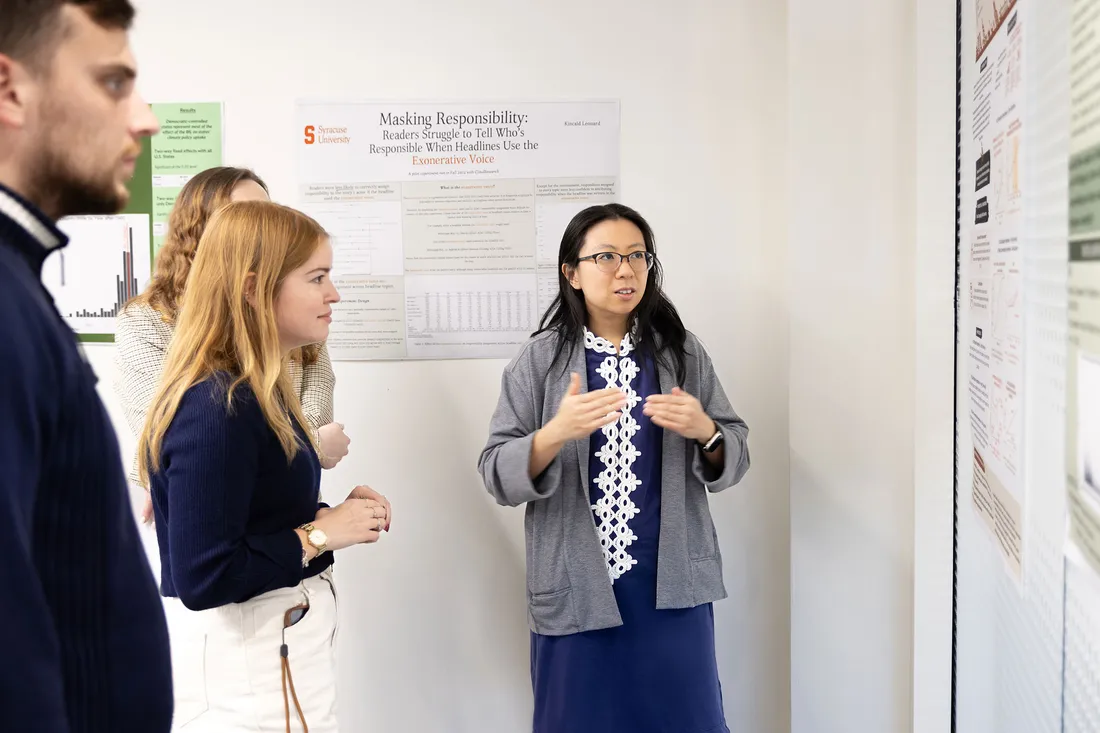 Professor presenting students her research.