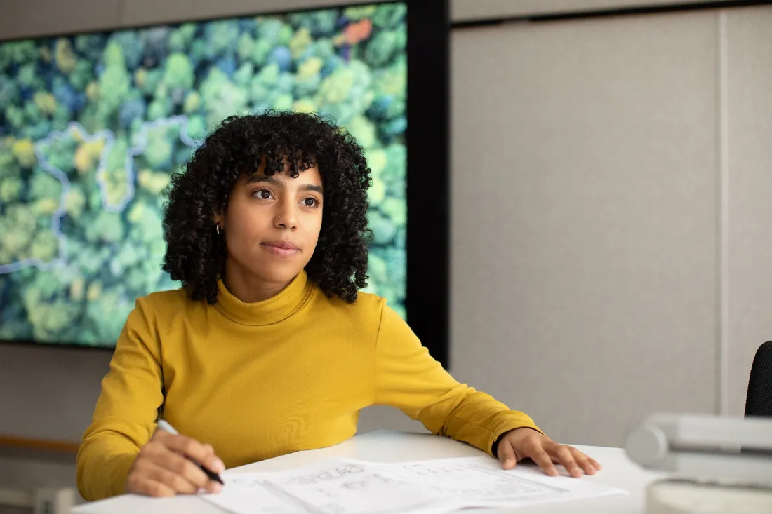 Nicole Aramboles sitting at a table with papers in front of her.